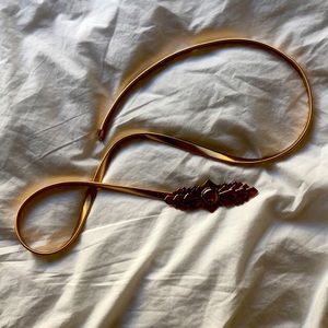 Stretchy slinky gold belt with sunburst buckle